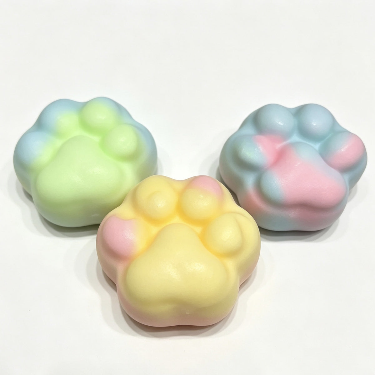 Pastel Paw Crunch — pastel paw-shaped crispy squishy being squeezed in hand